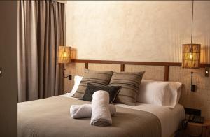 贝尼卡西姆Albades Hotel & Spa - Adults Only的一间卧室配有一张床,上面有两条毛巾