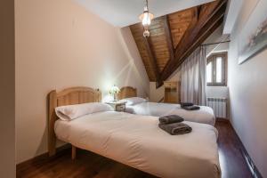 博索斯特Casa Garona by SeaMount Rentals的配有木天花板的客房设有两张床。