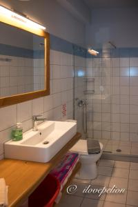 阿吉奥斯伊欧尼斯Uranus Blue Residence Agios Ioannis Papa Nero的一间带水槽、卫生间和镜子的浴室