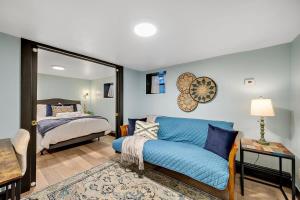 丹佛Charming & Updated Garden Level in Heart of Denver的客厅配有蓝色的沙发和床。