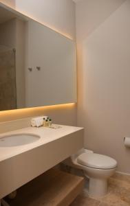 科韦尼亚斯Ciela Hotel & Beach Club的一间带水槽、卫生间和镜子的浴室