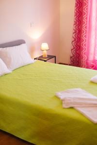 里贝拉迪佩纳CASA PAMPA的一间卧室配有一张绿床,桌子上配有一盏灯