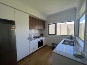 黄金海岸Stunning 3BR in Serene Loc Varied Amenities BBQ的厨房配有水槽和台面