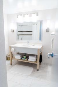 兰利海岸酒店&会议中心的白色的浴室设有水槽和镜子