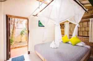 Tân PhúCat Tien Farm Stay的一间卧室配有一张带天蓬的床