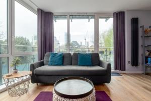 伦敦GuestReady - West wapping spot near Blitz Memorial的带沙发和大窗户的客厅