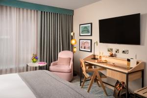 都柏林格林旅馆的酒店客房配有一张床、一张桌子和一把椅子。