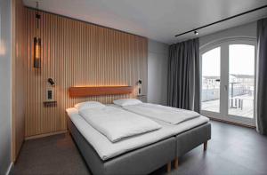 克厄Zleep Hotel Køge的一张位于带大窗户的房间内的床铺