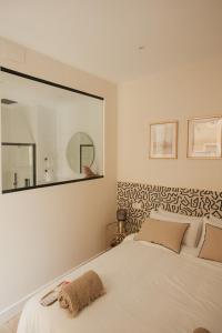 巴达霍斯Apartamentos Cervantes的卧室配有白色的床和大镜子