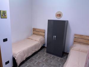 RoncopascoloIntero appartamento - Parma zona Fiera的客房设有两张床和黑色橱柜。