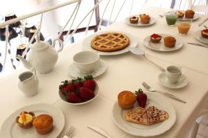 阿莱齐奥Palazzo Aurora的餐桌上放有食物和水果盘