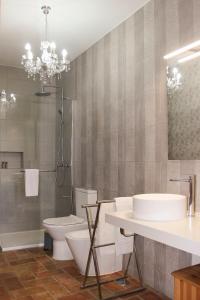 维拉诺瓦德卡塞拉Monte do Forno的一间带水槽、卫生间和吊灯的浴室