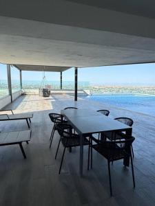 蒙特雷Lujoso departamento en Monterrey的一间带桌椅的海景用餐室
