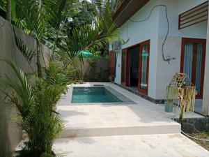 特贾库拉Villa Aditya的一座房子旁的院子内的游泳池