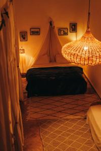 马拉喀什NOSADE Venue的一间带帐篷和吊灯的卧室