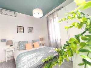 圣贝内代托-德尔特龙托Delizioso Bilocale Balilla Centralissimo Int 4的白色卧室配有带橙色枕头的床