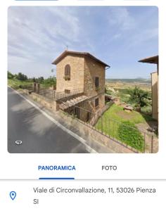皮恩扎Il Nido的一张带有建筑物照片的网站的截图