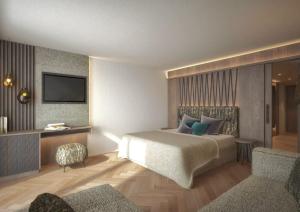 布鲁尼科Majestic Hotel & Spa Resort的卧室的 ⁇ 染,配有一张床和电视