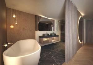布鲁尼科Majestic Hotel & Spa Resort的一间位于客房内的带白色浴缸的浴室