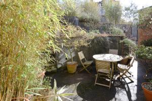 海斯廷斯The Cloudesley Guesthouse的花园内带桌椅的庭院