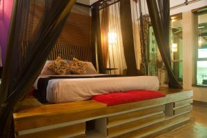 本托塔Red Coconut Villa的一间卧室配有一张带木制床架的床