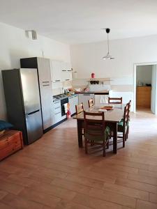 庞特卡格纳诺House Edda Serena - Casa Vacanze Salerno的厨房配有桌椅和冰箱。