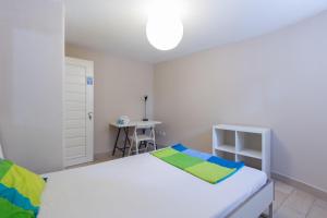 波尔图Relógio Guest House的卧室配有白色的床和书桌