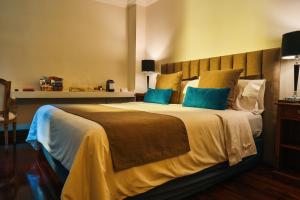 布宜诺斯艾利斯摩拉维亚苏豪酒店的一间卧室配有一张带蓝色枕头的大床