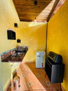 布鲁马迪纽Rancho Ubuntu的一间带水槽和冰箱的小厨房