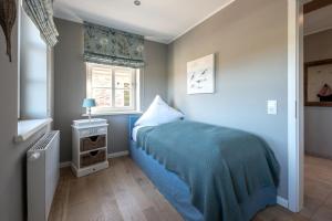 斯匹科罗格Meersalz的一间卧室设有蓝色的床和窗户。