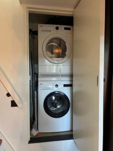 Velserbroek Cozy & Modern Tiny House的小房间里的洗衣机和烘干机