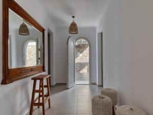 法纳里Gorgeous Mykonos Villa | 4 Bedrooms | Villa Atalanta | Private Pool & Panoramic Sea Views | BBQ | Faros的走廊上设有镜子、凳子和椅子