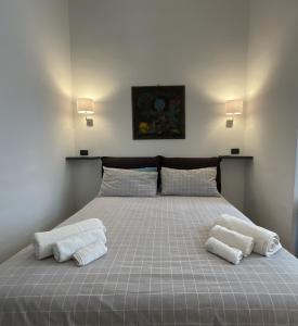 都灵NONPERTUTTI PIAZZA CASTELLO Senior e famiglie TOP的一间卧室配有一张床,上面有两条毛巾