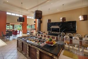奇帕塔奇帕塔普罗蒂亚酒店的厨房提供自助餐,餐桌上供应食物