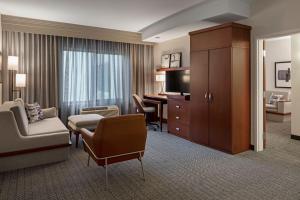 长滩长滩机场万怡酒店的酒店的套房设有书桌和客厅。