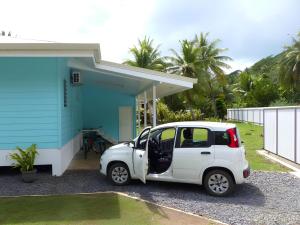 PatioLuxury Waterfront Bungalow + Car的停在蓝色房子前面的白色汽车