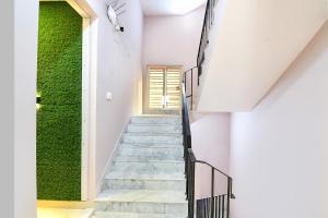 加尔各答FabHotel The Sunshine Residency的绿色墙壁房子的楼梯