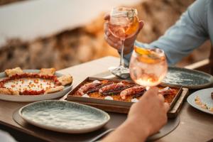 卡兰博希Lago Resort Menorca - Casas del Lago Adults Only的餐桌,餐盘和一杯葡萄酒