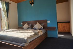 马拉里Hostelgia的一间卧室配有一张蓝色墙壁的床
