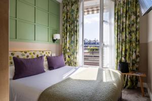 巴黎克莱门特酒店的一间卧室设有一张大床和一个窗户。