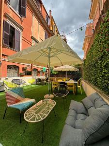 罗马罗马自由青年旅舍的庭院配有桌椅和遮阳伞。
