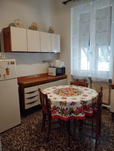 热那亚MAISON SAN FRUTTUOSO的厨房配有桌子和冰箱
