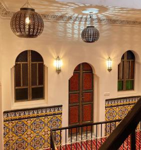 丹吉尔Zoco Riad的一座带两扇门的建筑,一座带灯光的楼梯