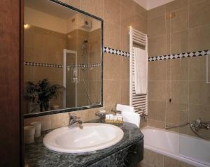 圣文森特德拉别墅酒店的浴室配有盥洗盆、镜子和浴缸