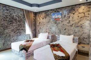 Buengngarm Resort的石墙客房的两张床