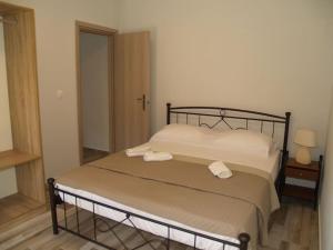 凯法利尼亚岛Casa Cimara的一间卧室配有一张床,上面有两条毛巾