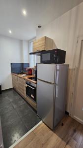 布雷斯特Maisonnette tout confort.的厨房配有不锈钢冰箱和橱柜