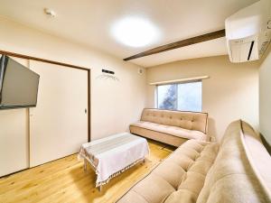 新宫市Kokoyui Guesthouse Shingu的带沙发和电视的客厅