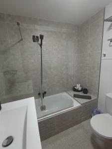 科斯塔德安提瓜Apartamento London Complex Amaya Fuerteventura的带浴缸和卫生间的浴室。