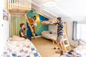 比亚里茨SURF HOSTEL BIARRITZ的一组人在卧室里,卧室里配有双层床